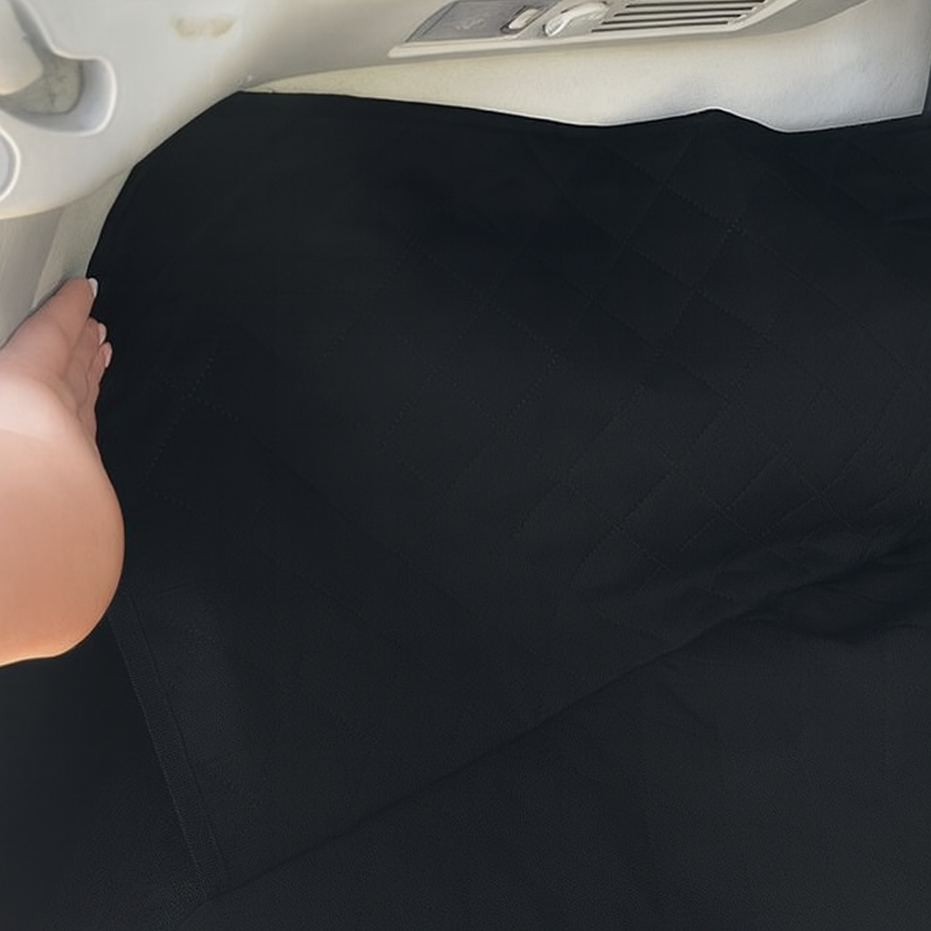 Black car seat cover being adjusted inside a vehicle