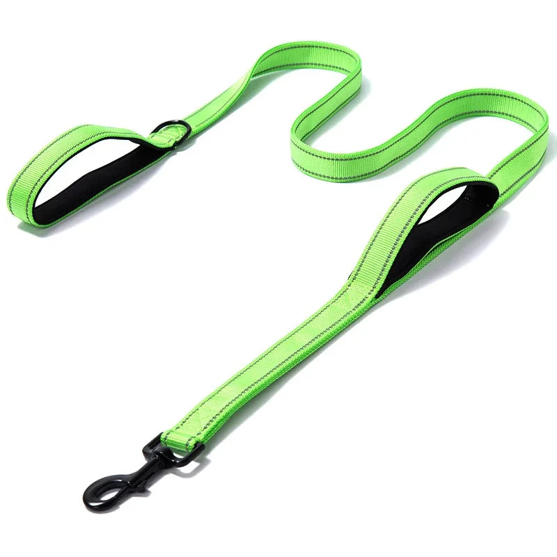 Neon green dog leash with black clip on a white background