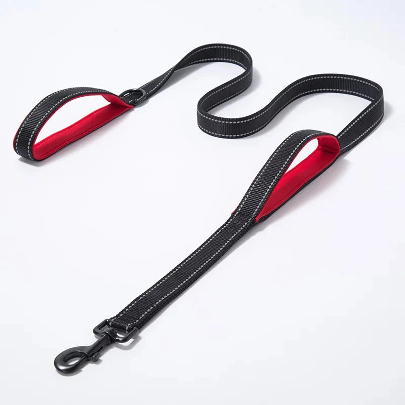 Black dog leash with red interior on a white background