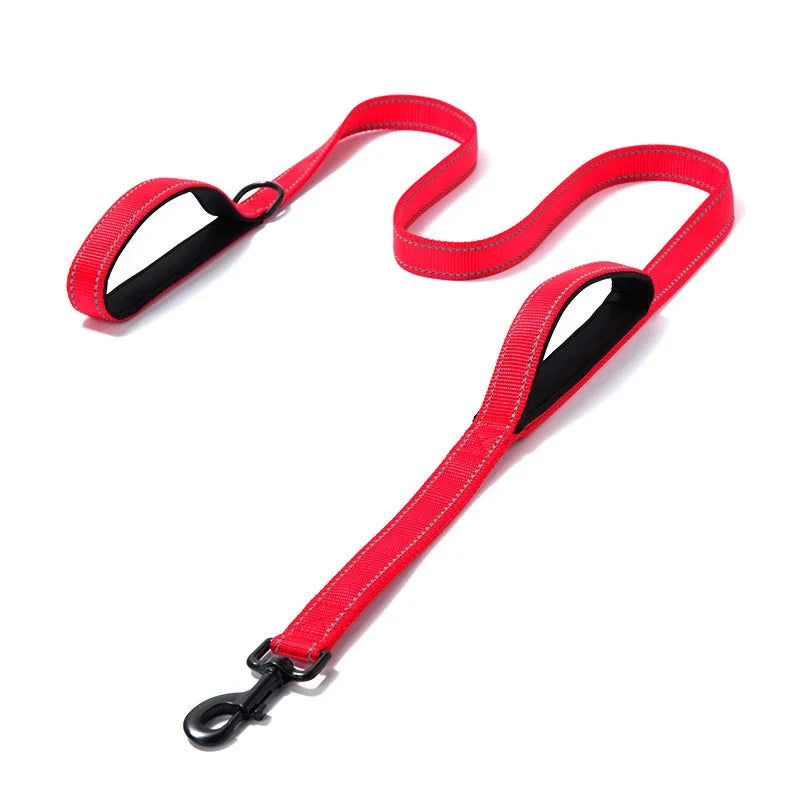 Red dog leash with black clip on a white background