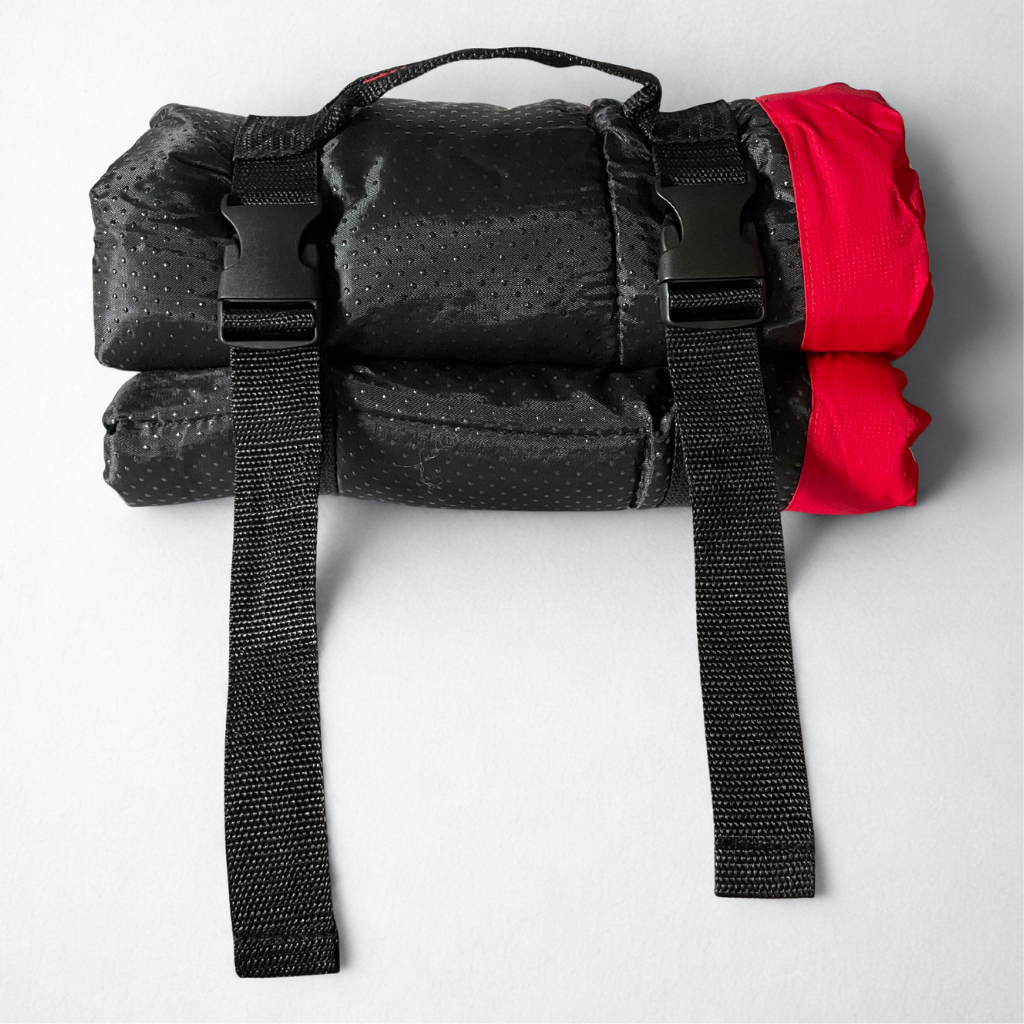 Black roll-up bag with red accents on a white background