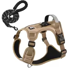 Tan dog harness with black leash on a white background